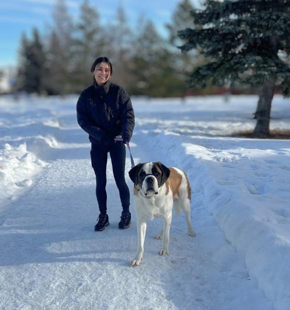 Grace, Dog Jogs team member walking a dog in St. Albert